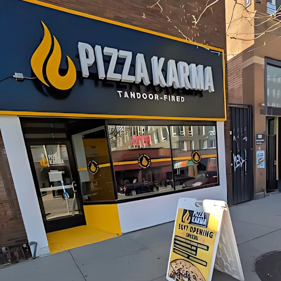 Pizza Karma restaurant exterior featuring a welcoming entrance and a sign announcing its opening.