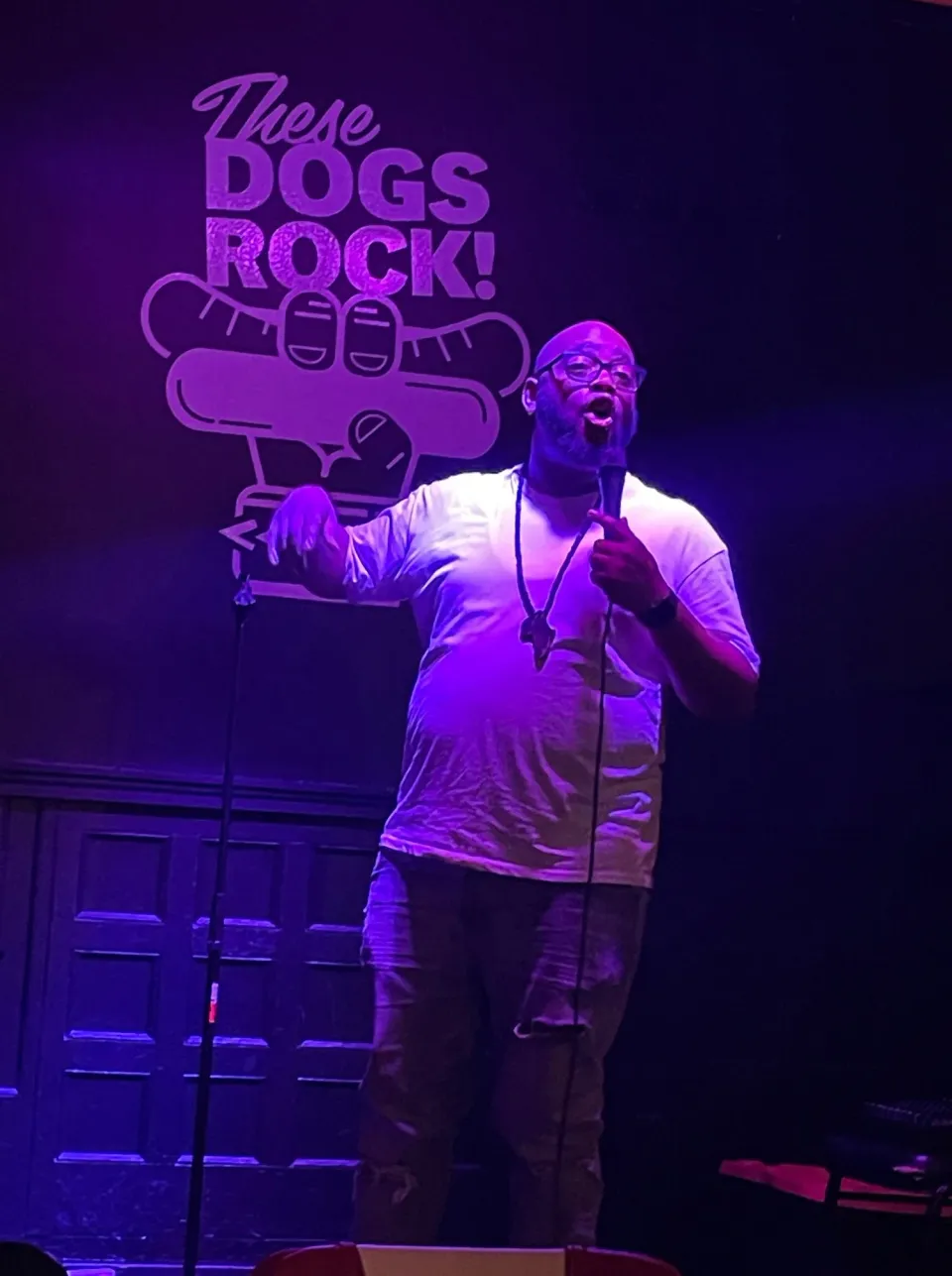 A stand up comedian tells jokes on stage at Steve's Hot Dogs St Louis