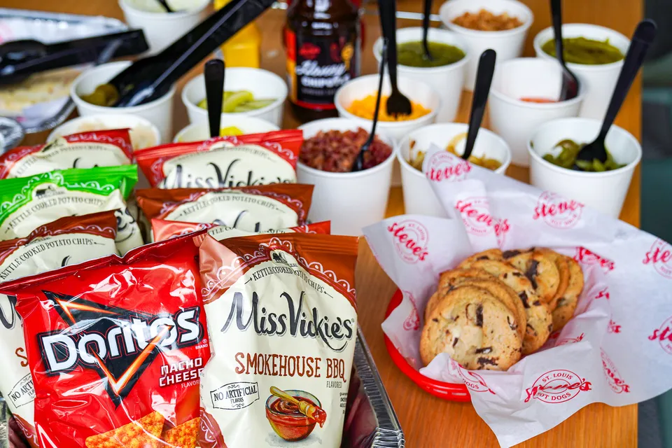 toppings cookies and bags of chips on a table