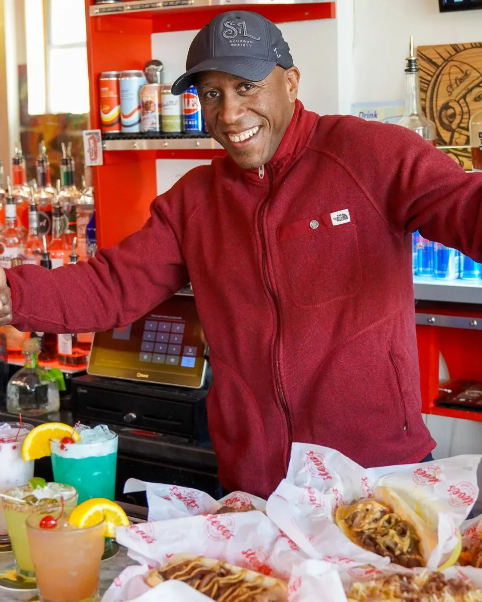 Steve Ewing stands before catered food