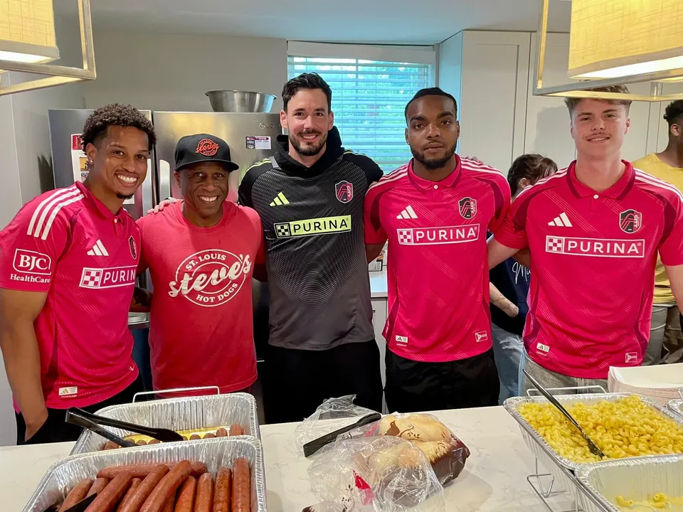 Steve caters for St Louis City SC - Steve Ewing stands with 4 players in front of food
