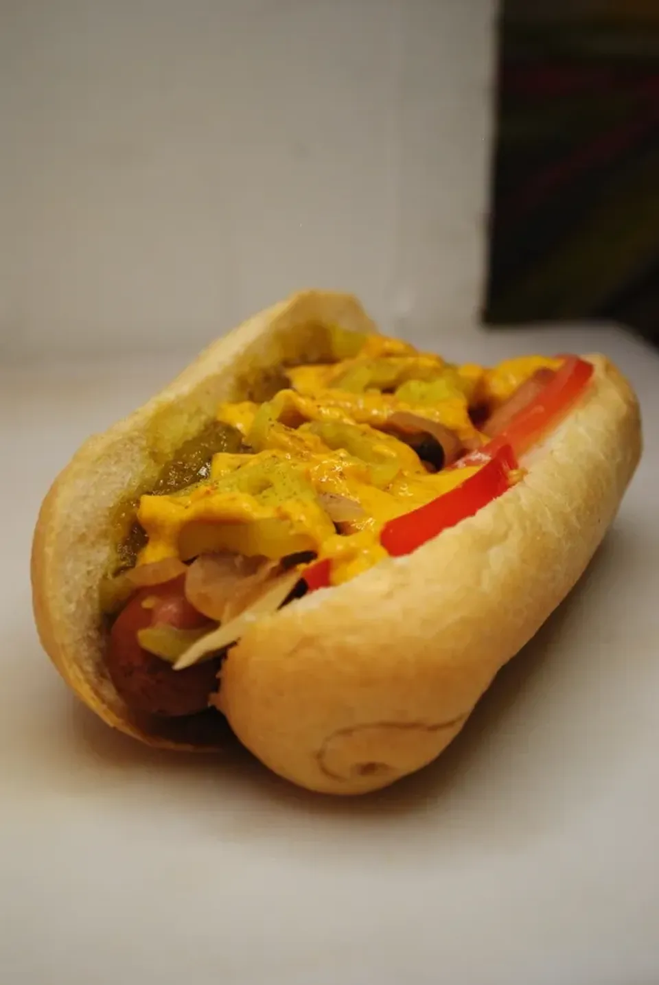 A Vegan Hot Dog on a bun with mustard and veggies