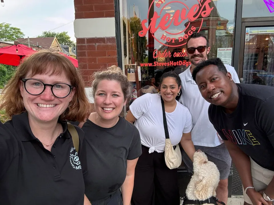 Our friends at Helping Hand Me Downs host a fundraiser at Steve's on South Grand! A picture of 5 smiling faces standing outside the restaurant.